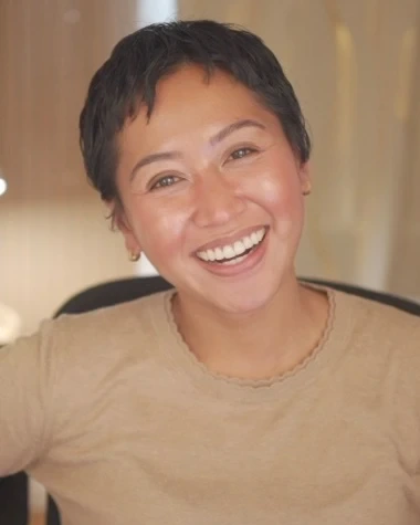 Helen Bass, LCSW, laughing in a tan top